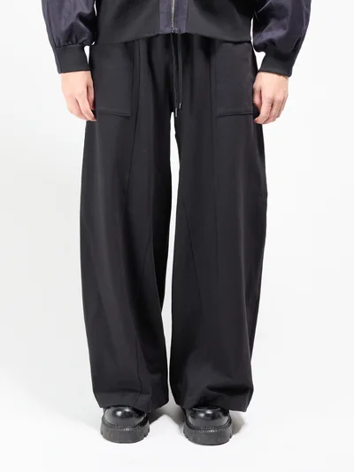 Black track pants, front view