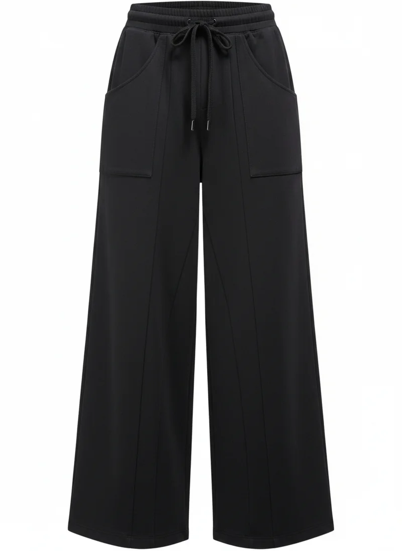 Black track pants, detail